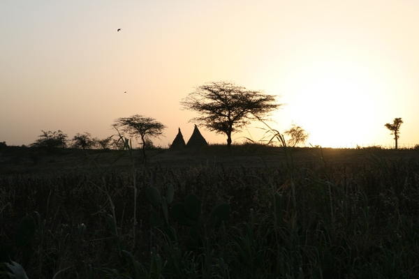 Sunset over a couple of traditional dwellings in Meki, in the Ethiopian Rift Valley